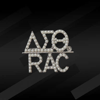 A pearl-encrusted pin featuring the DST Greek letters and the RAC symbol.
